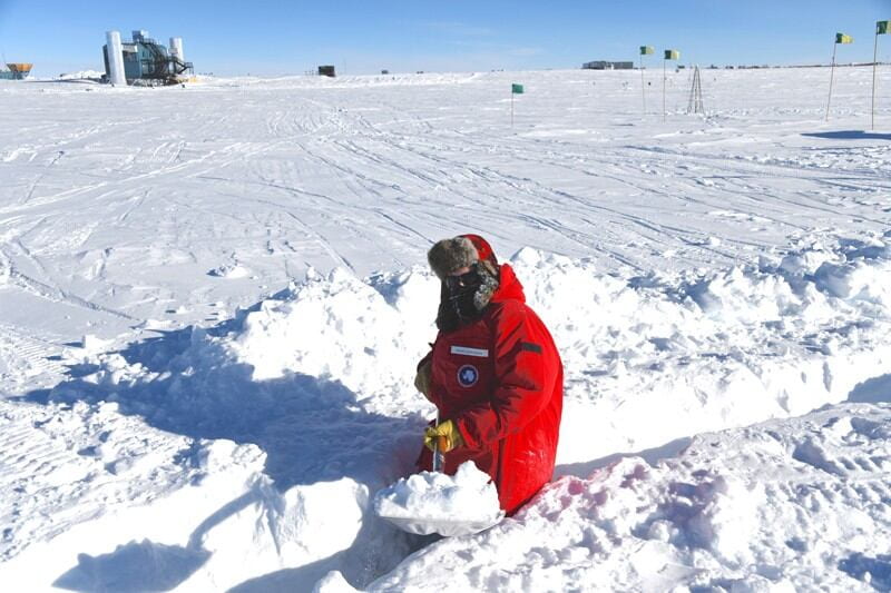 With the IceCube Laboratory in the distance, UD physicist Frank Schroeder shovels a trench for cables leading to a radio antenna he deployed at the South Pole in January 2020. Photos courtesy of Frank Schroeder, Alan Coleman and the IceCube Collaboration